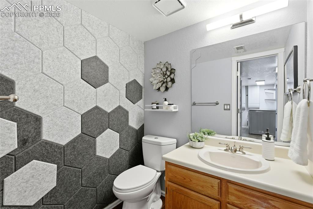 Image 33 of 45: Bathroom featuring toilet and vanity