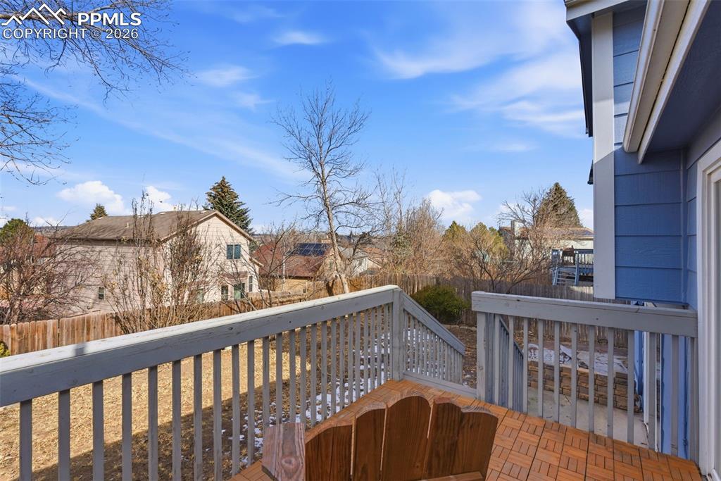 Image 37 of 45: Wooden terrace with a fenced backyard and a residential view