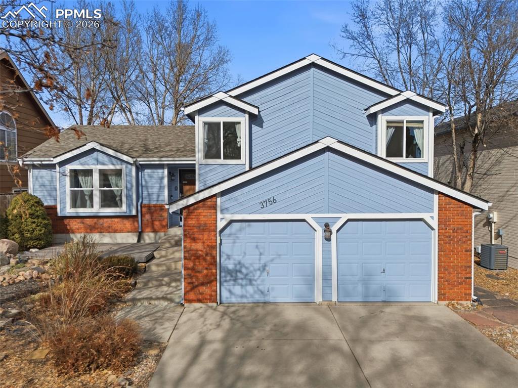 Image 41 of 45: View of front of home with concrete driveway and an attached garage