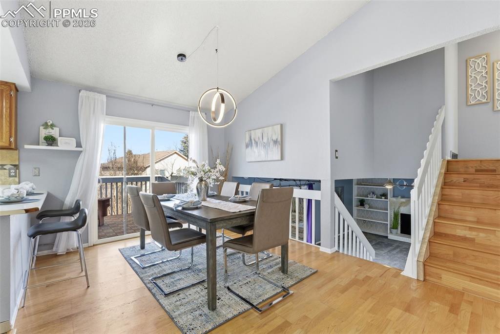 Image 5 of 45: Dining area featuring lofted ceiling, light wood-type flooring, and suspend