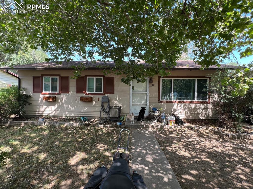 Image 2 of 6: View of front of home featuring a shingled roof