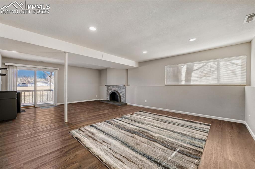 Image 29 of 48: Lower level Family room, plumbed for wet bar and wood burning fireplace.