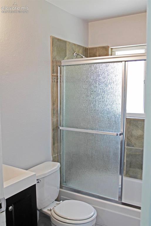 Image 10 of 12: Bathroom featuring a white vanity with a dark wood-finish cabinet, a white 