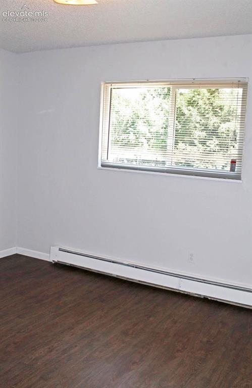 Image 11 of 12: Wood-finish flooring, white walls, horizontal window blinds, and a ceiling-