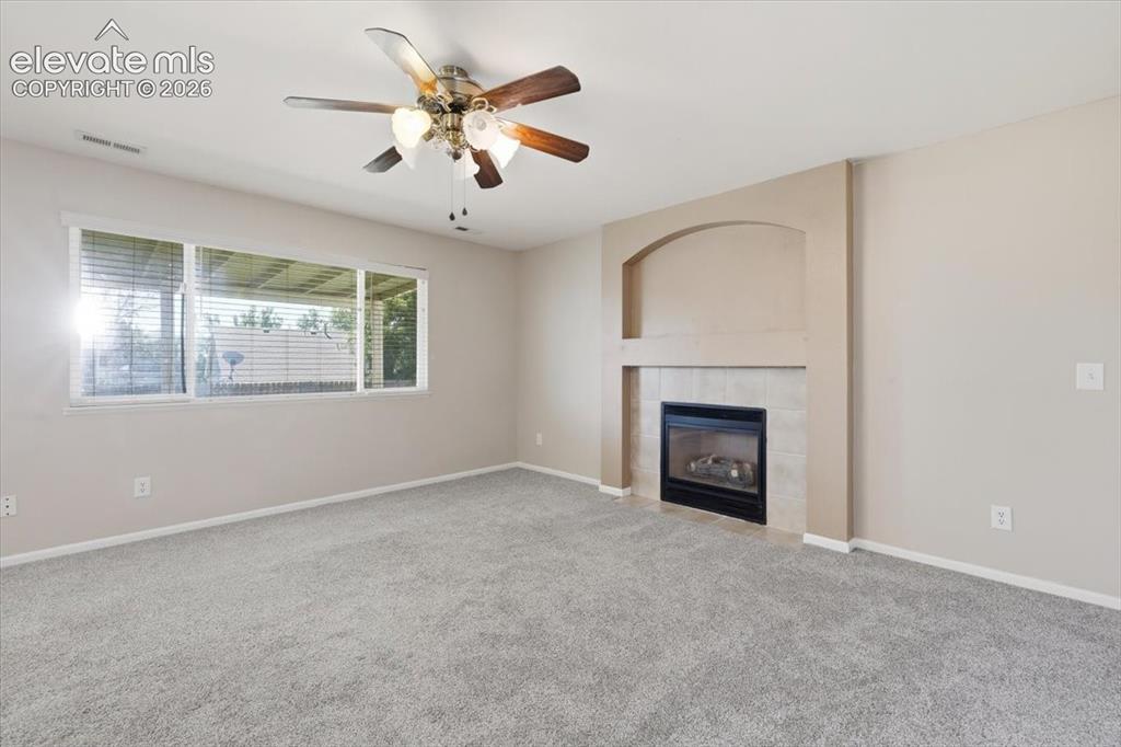 Image 17 of 43: Family room with gas fireplace.