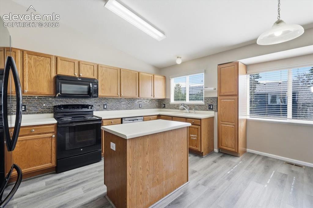 Image 9 of 43: Large kitchen with center island.