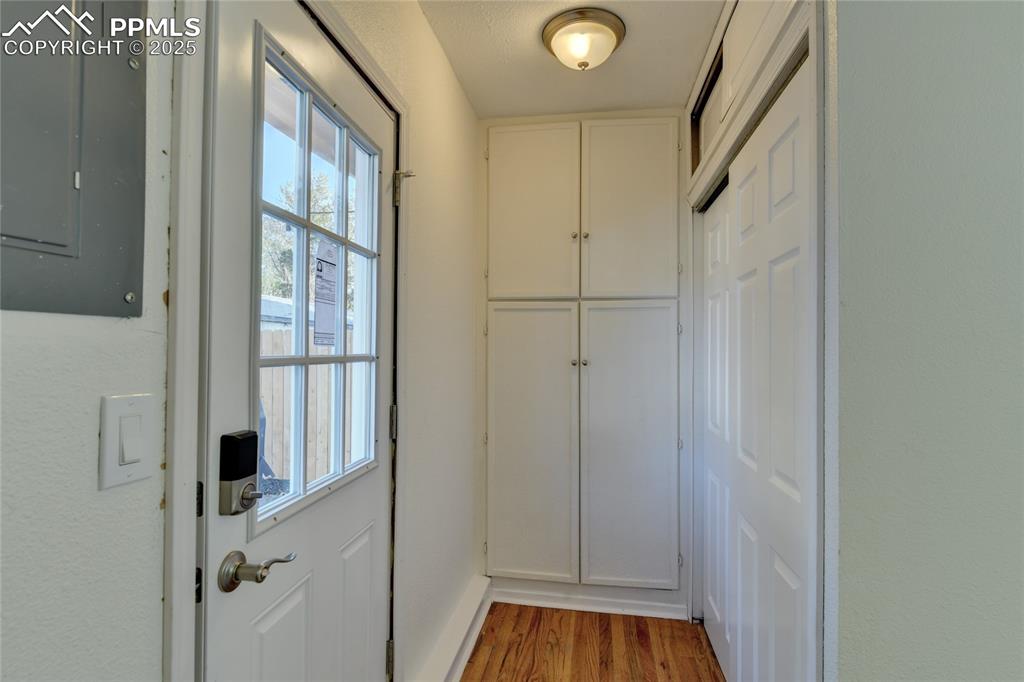 Image 26 of 37: Built in cabinets and pantry/closet by the back door. Both the Front Door a