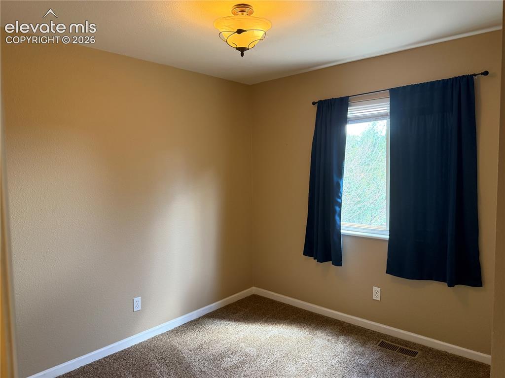 Image 9 of 17: Neutral wall finishes, recessed window, and carpeted flooring in upper bedr