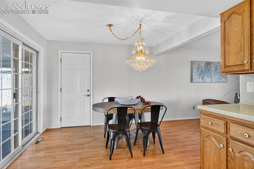 Image 18 of 40: Another view of the dining area and door to attached garage!