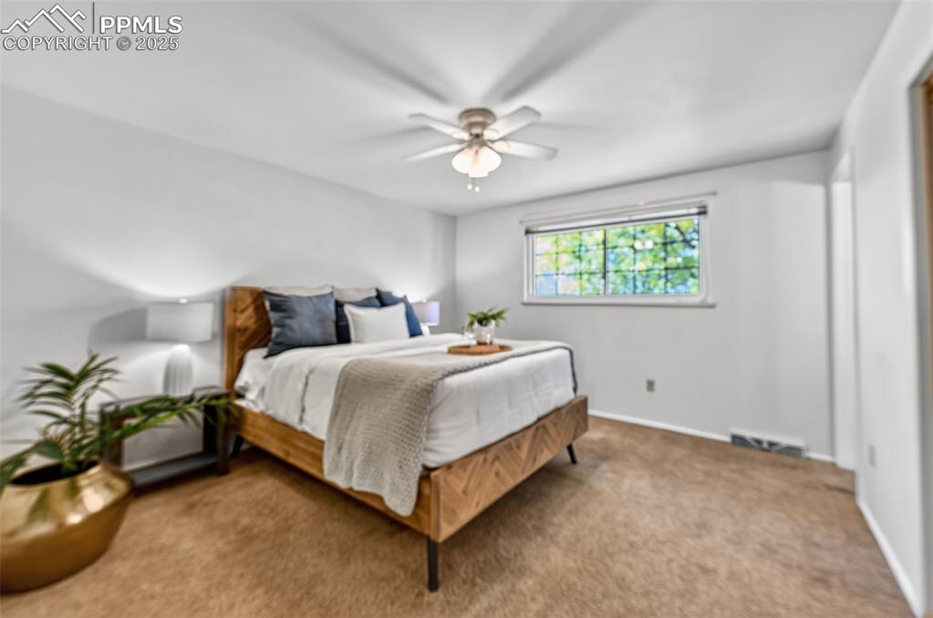 Image 22 of 40: Spacious master bedroom with ceiling fan!