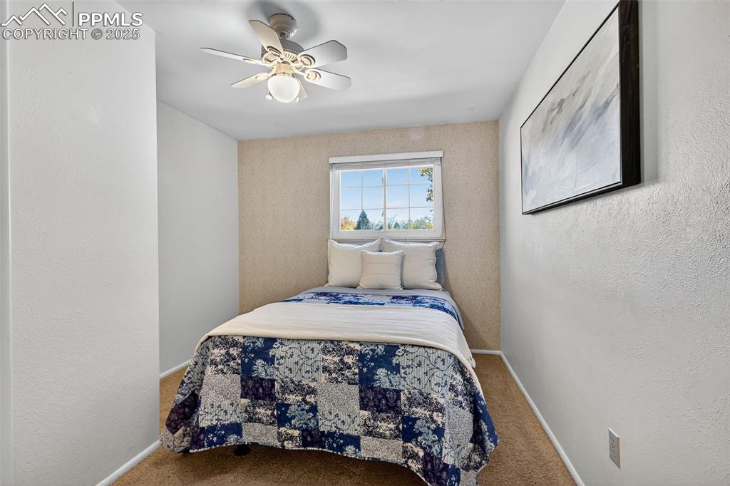Image 26 of 40: Third bedroom upstairs with ceiling fan!