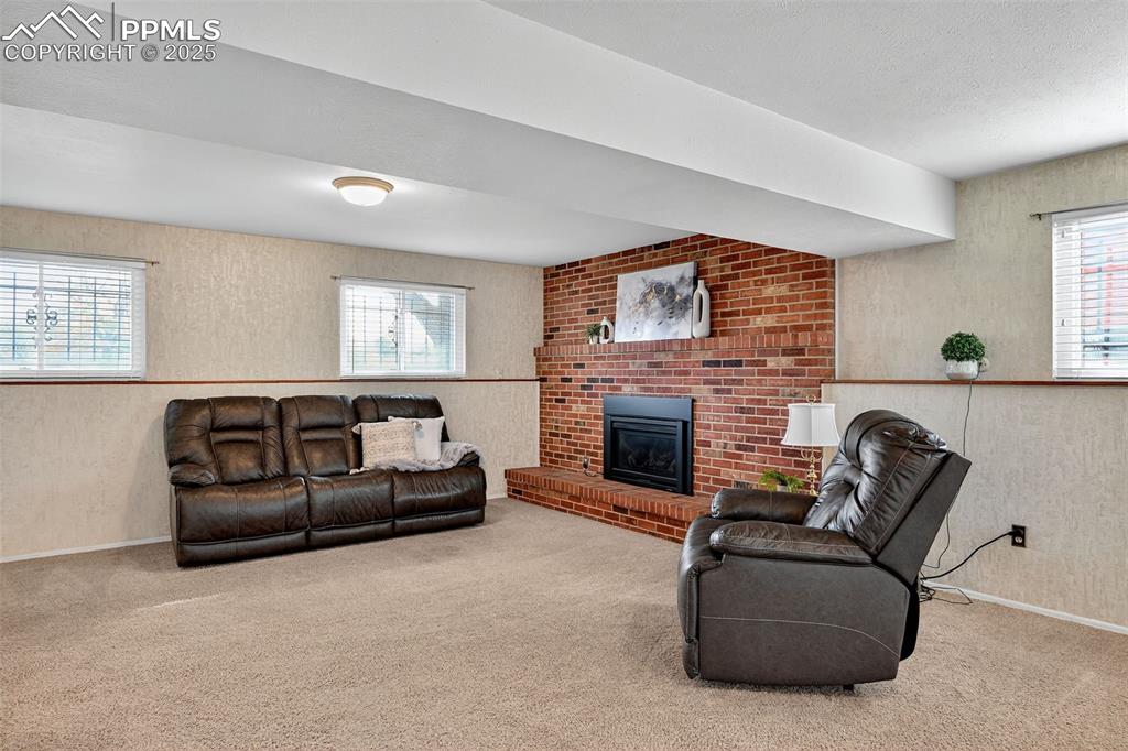 Image 28 of 40: Spacious basement with cozy fireplace!