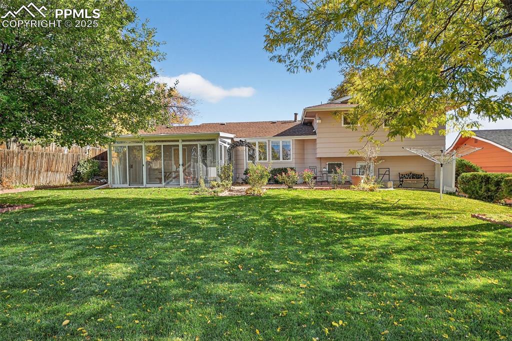 Image 36 of 40: Wow!  Sun room has sliding doors on all three sides for indoor/outdoor livi