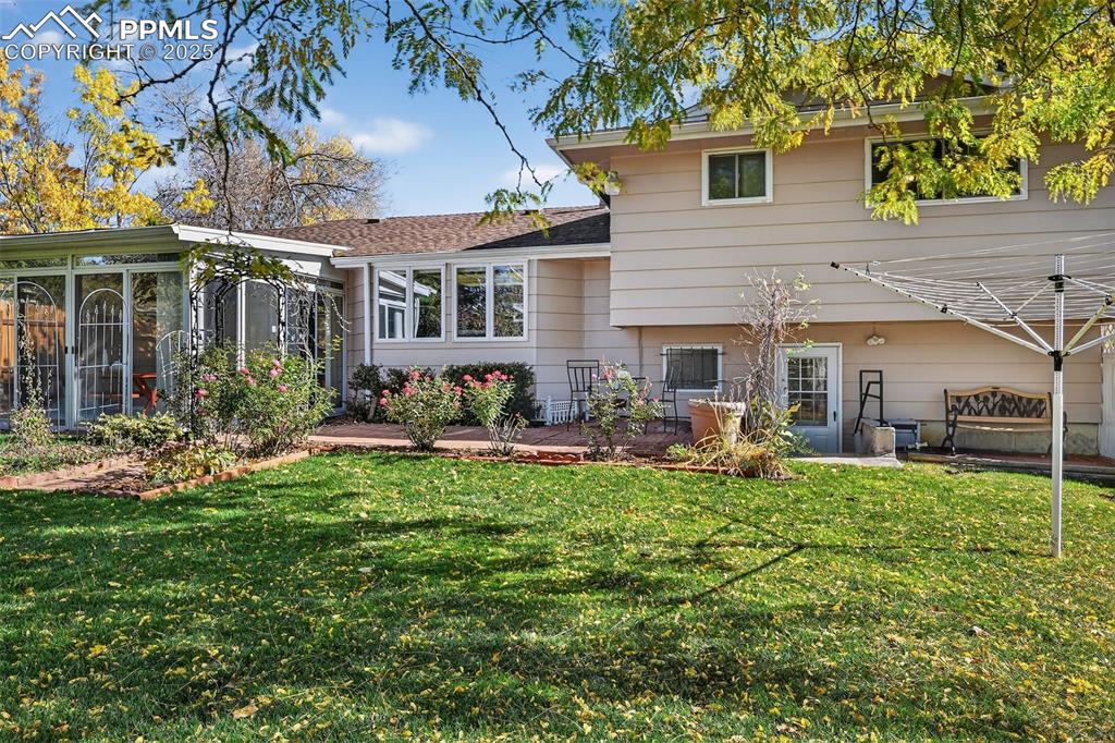 Image 37 of 40: Brick patio and arched trellis bring charm to the back yard!