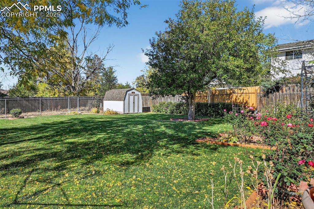 Image 38 of 40: Storage shed and lovely landscaping!