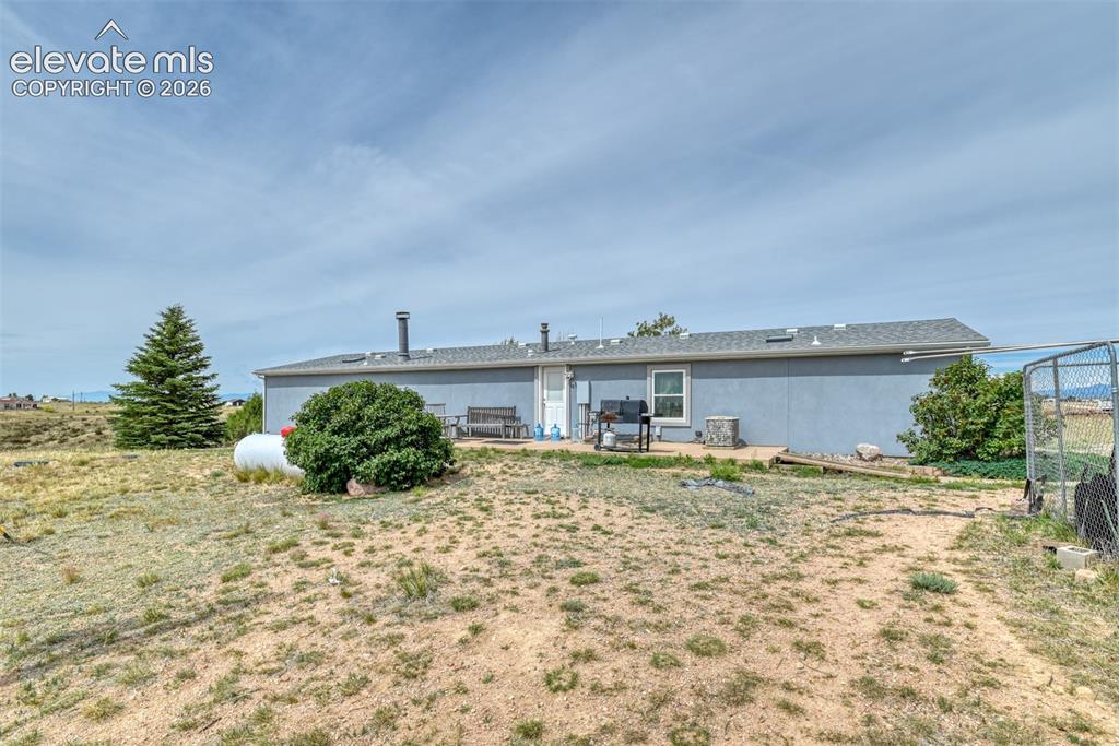Image 15 of 37: Single-story exterior with light blue siding, a gray shingle roof, and a vi