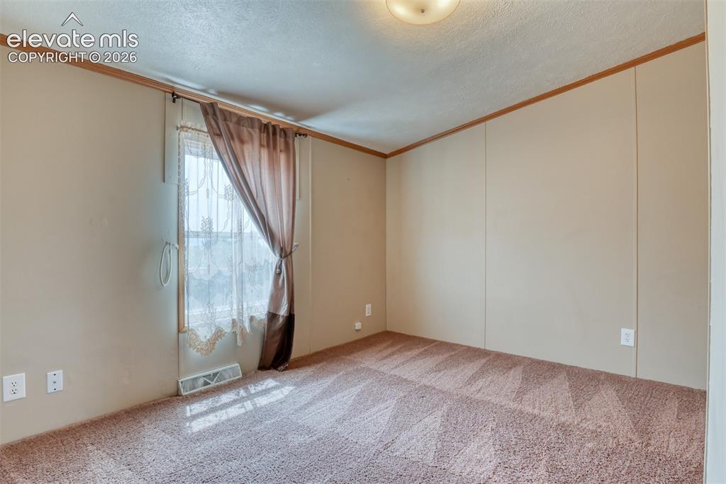 Image 20 of 50: Interior space featuring a window with sheer and blackout curtains, ceiling