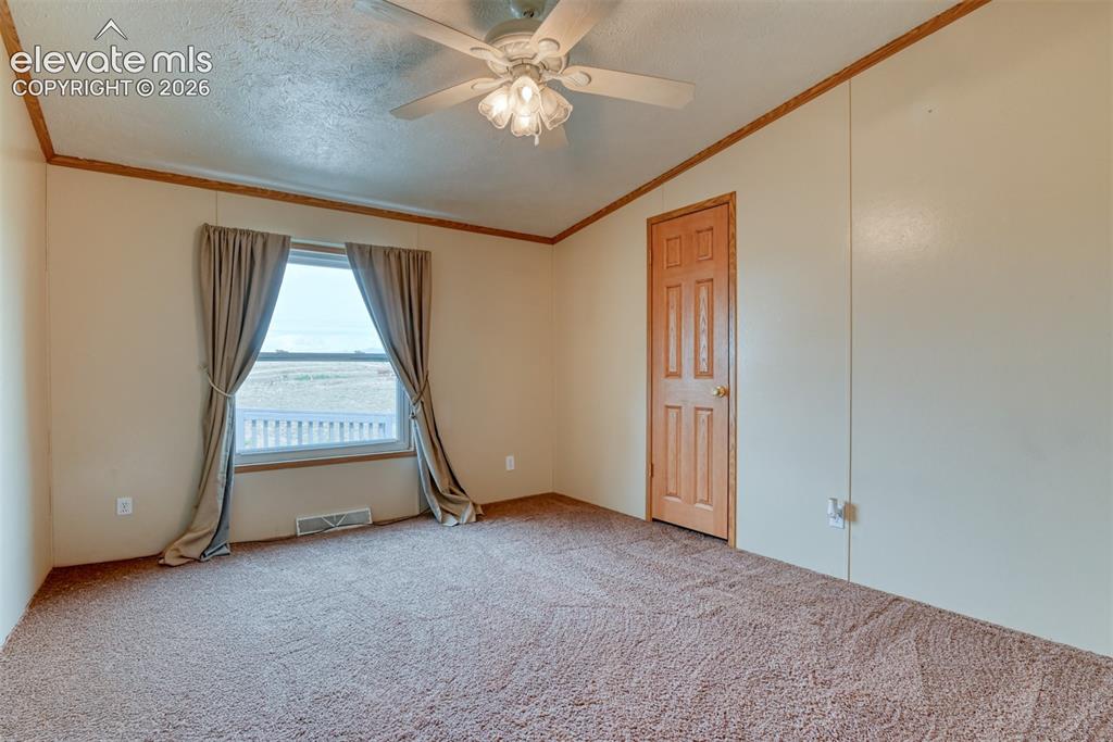 Image 27 of 50: Carpeted interior space featuring a ceiling fan with integrated lighting, a