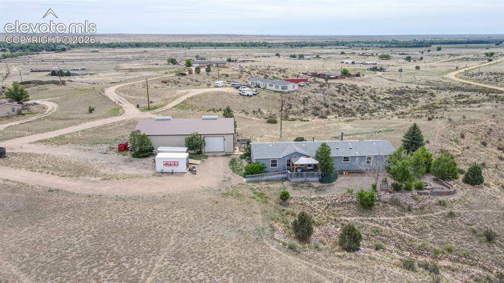 Image 34 of 37: Expansive acreage featuring a single-story residence with a covered porch a