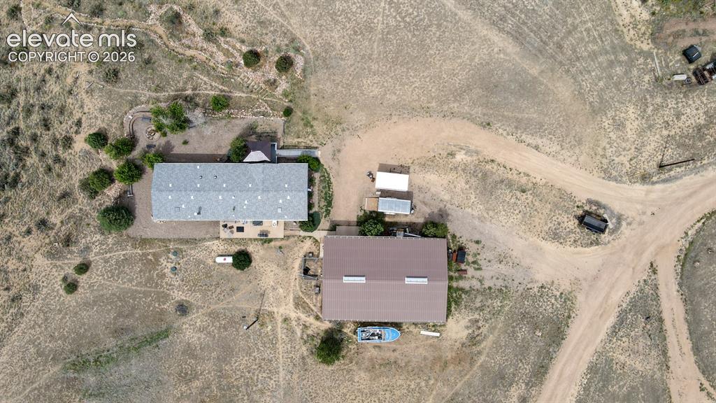 Image 36 of 37: Expansive property featuring two distinct structures with pitched roofs, su