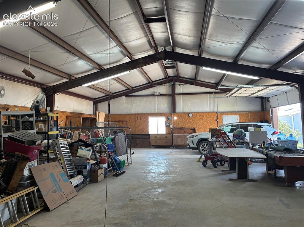 Image 4 of 37: Spacious metal building featuring an open-span interior with exposed steel
