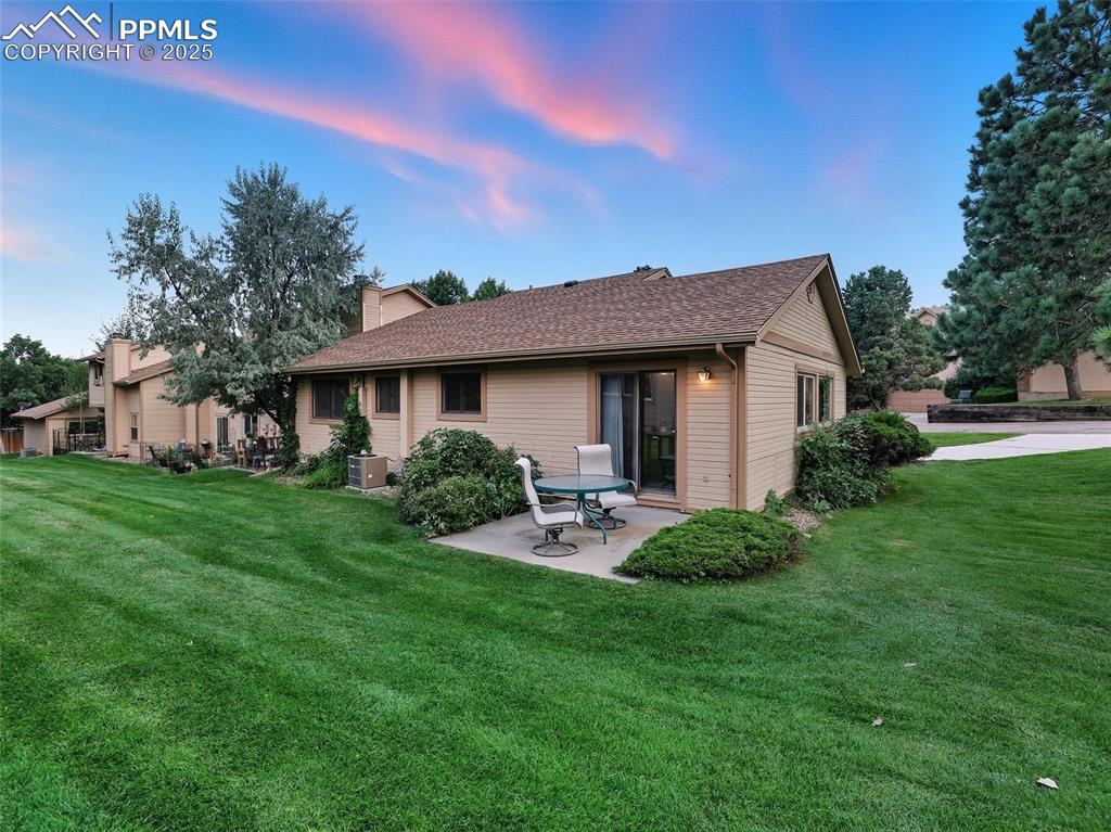 Image 11 of 36: Rear patio also has serene views of the lush landscaping.
