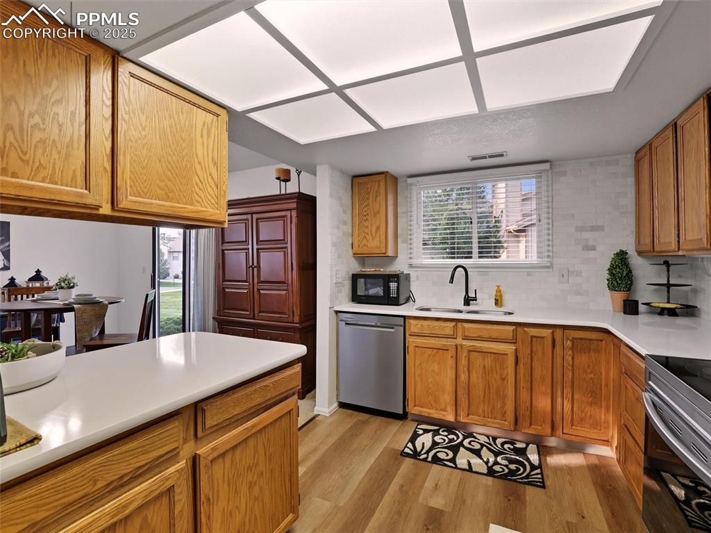 Image 18 of 36: Kitchen updates include quartz counters and stainless applicances