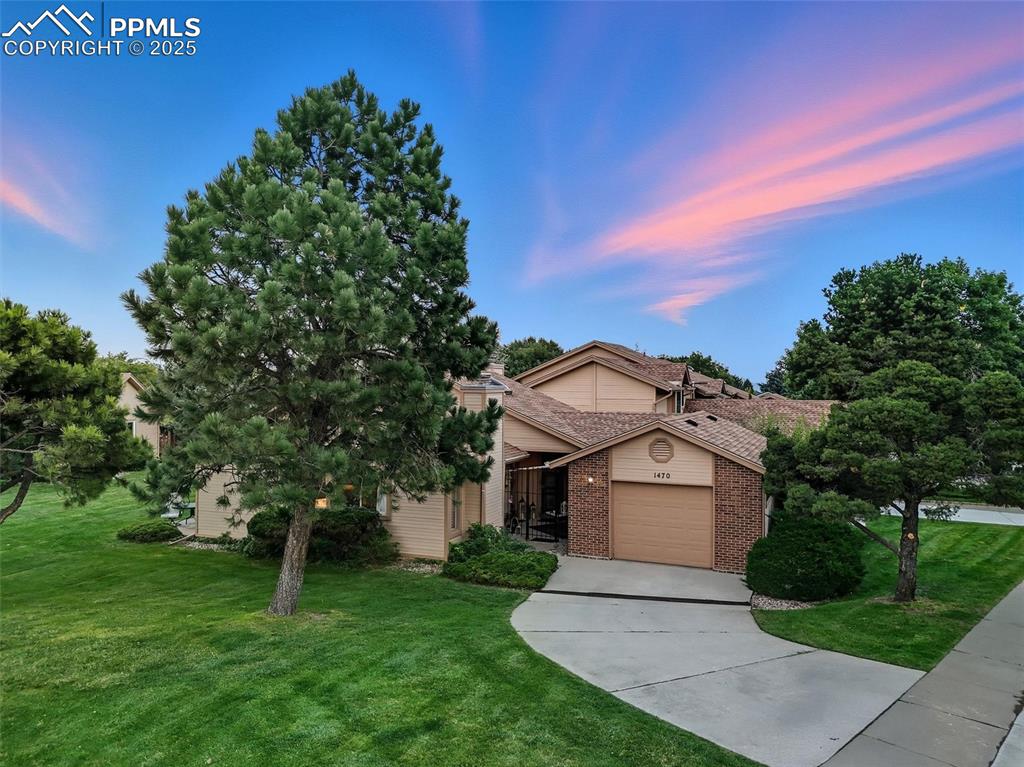 Image 2 of 36: Well-maintained and manicured landscaping and a lovely curved driveway