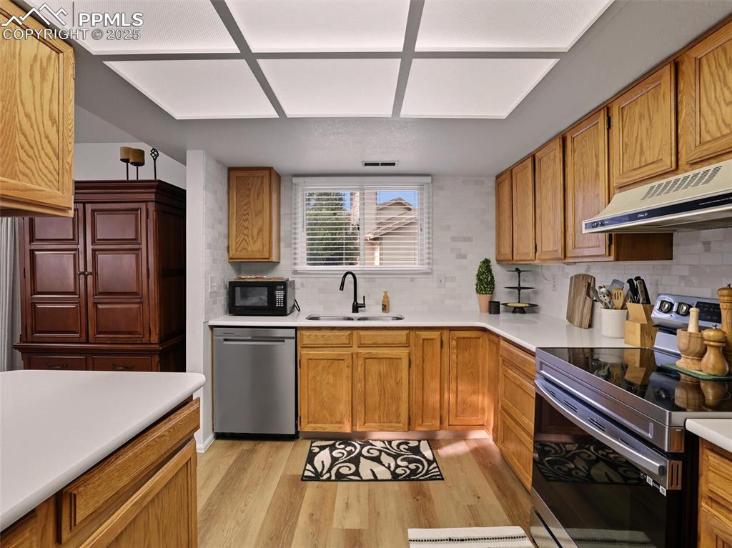 Image 20 of 36: Kitchen window for a more views of the well cared for landscaping