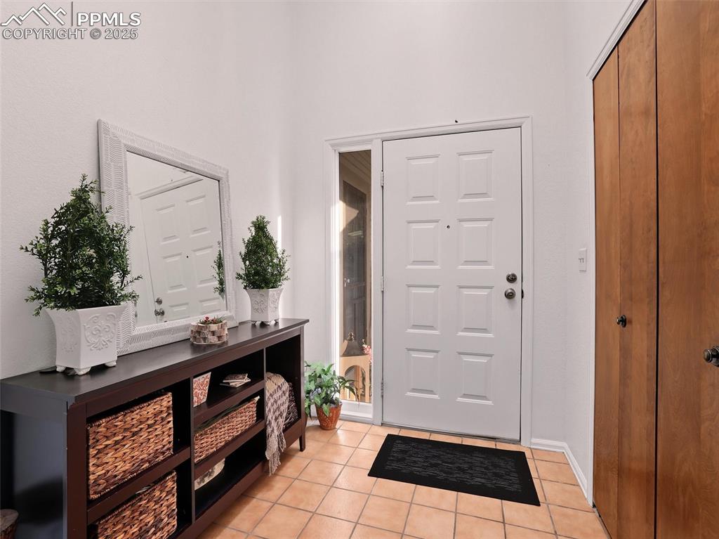 Image 6 of 36: Entrance foyer with skylight to fill the space with natural light