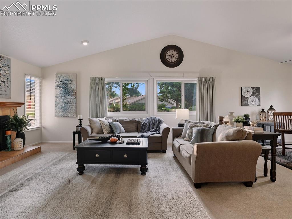 Image 7 of 36: Grand living room with vaulted ceilings and large windows