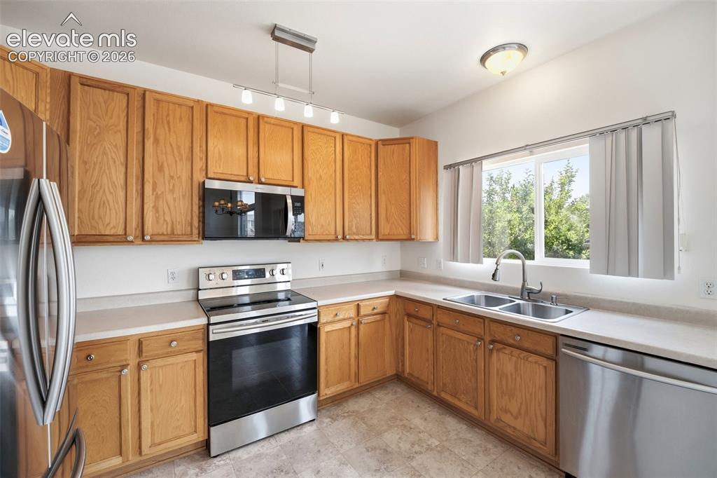 Image 12 of 48: Kitchen featuring light wood cabinetry, light-toned countertops, and a wind