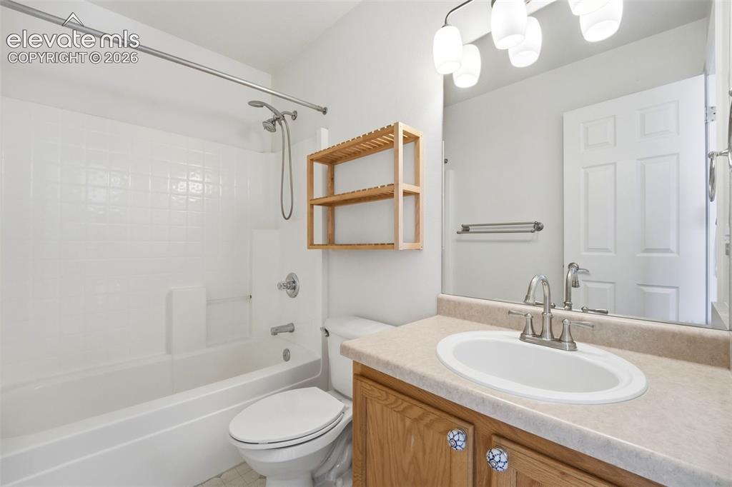 Image 19 of 48: Bathroom with white subway tile shower surround, chrome shower fixtures, an