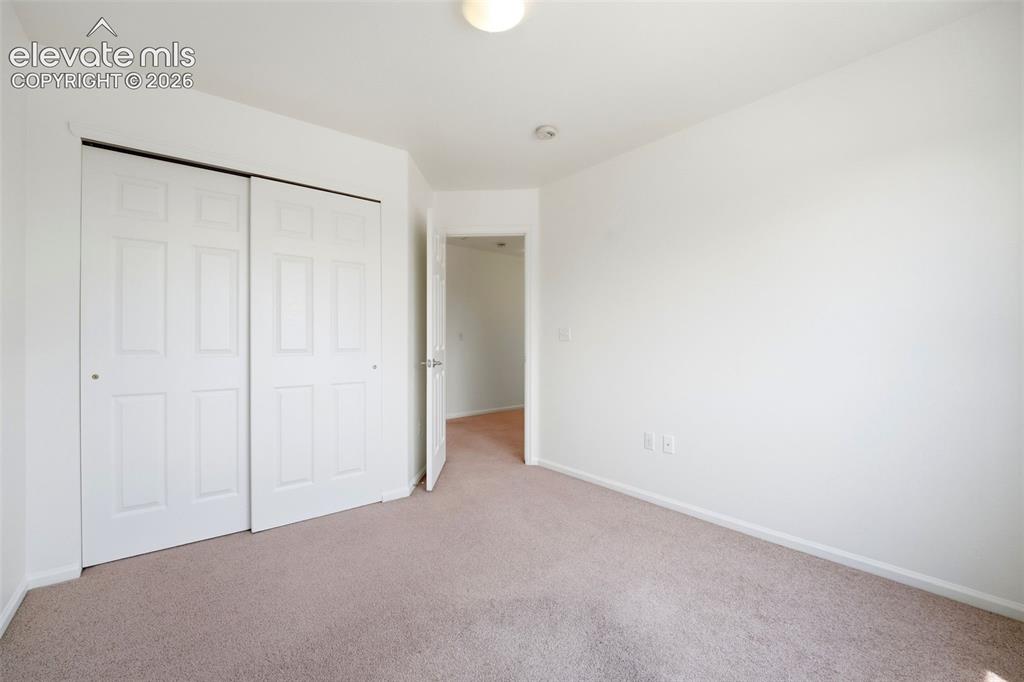 Image 27 of 48: Neutral-toned carpeting complements the light-colored walls in this space