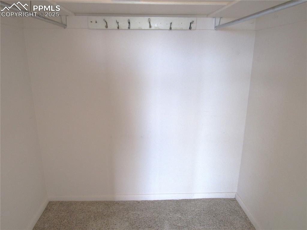 Image 14 of 25: Walk-in closet in primary bedroom