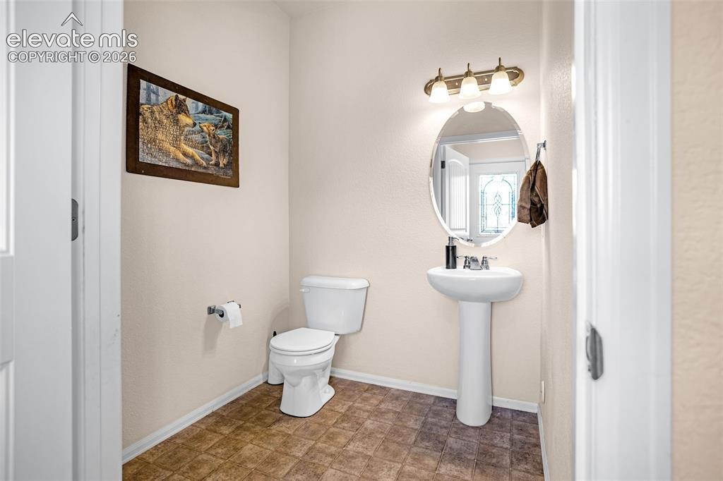 Image 12 of 38: Main floor bathroom featuring toilet and baseboards