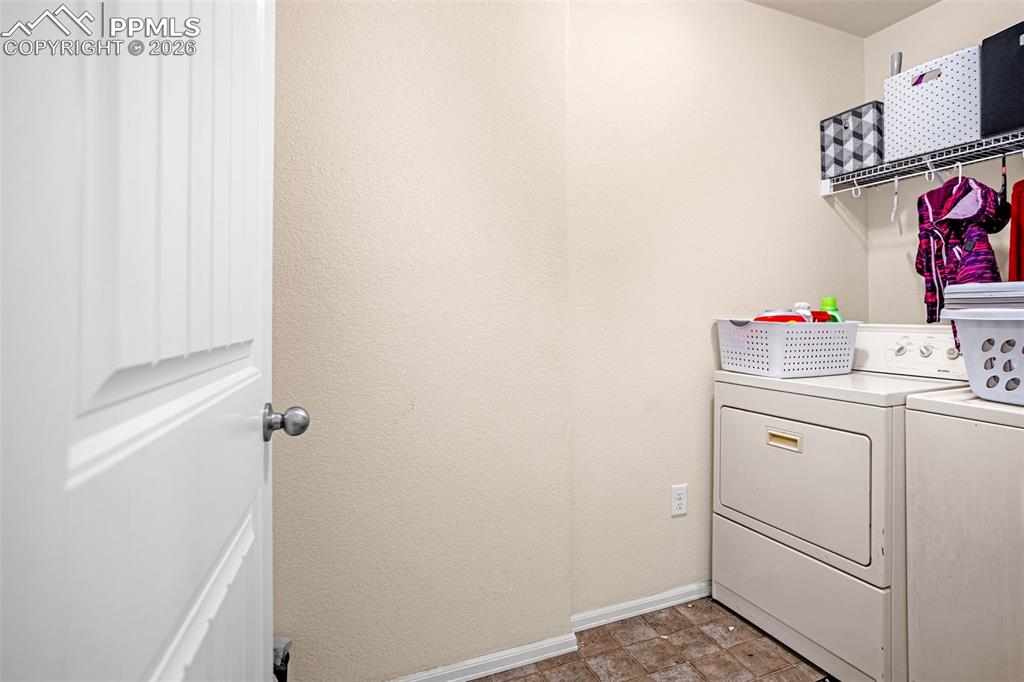 Image 15 of 30: Laundry room with baseboards and separate washer and dryer