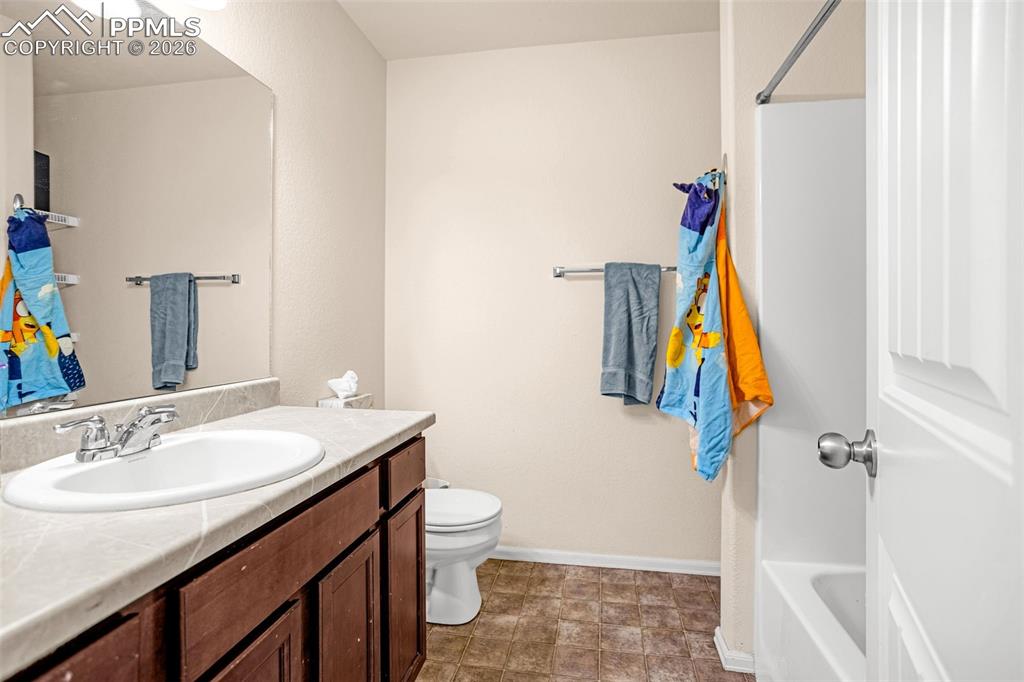 Image 16 of 30: Full bathroom with vanity and toilet