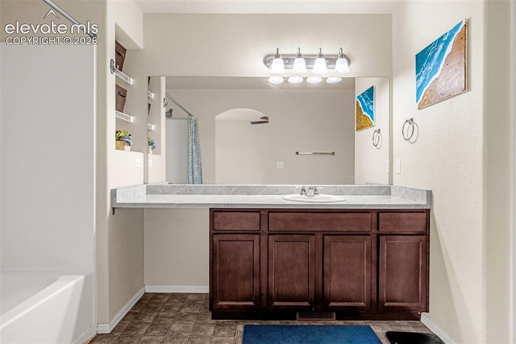 Image 16 of 38: 2nd Upstairs Bathroom featuring a single vanity with a solid surface counte