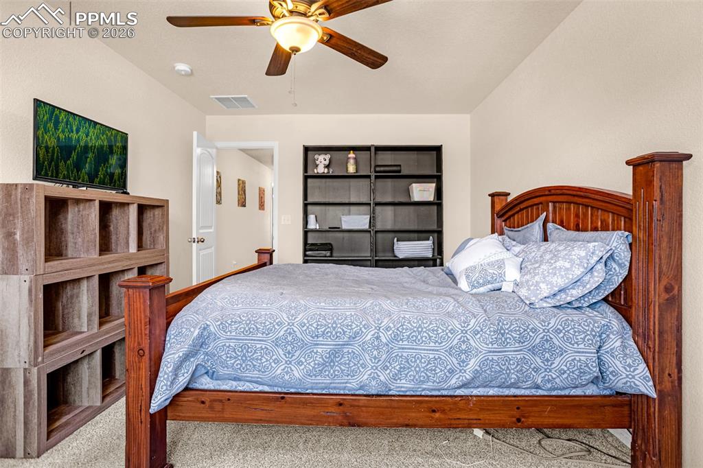 Image 18 of 30: Bedroom featuring a ceiling fan and carpet