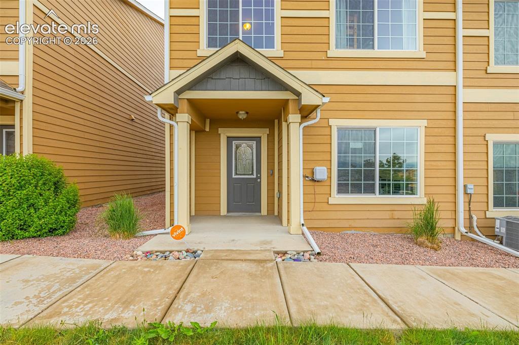 Image 2 of 38: Entryway featuring a covered porch, paneled door with decorative glass inse