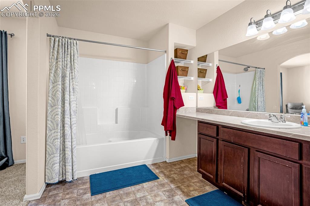 Image 20 of 30: Bathroom with vanity and shower / bath combination with curtain