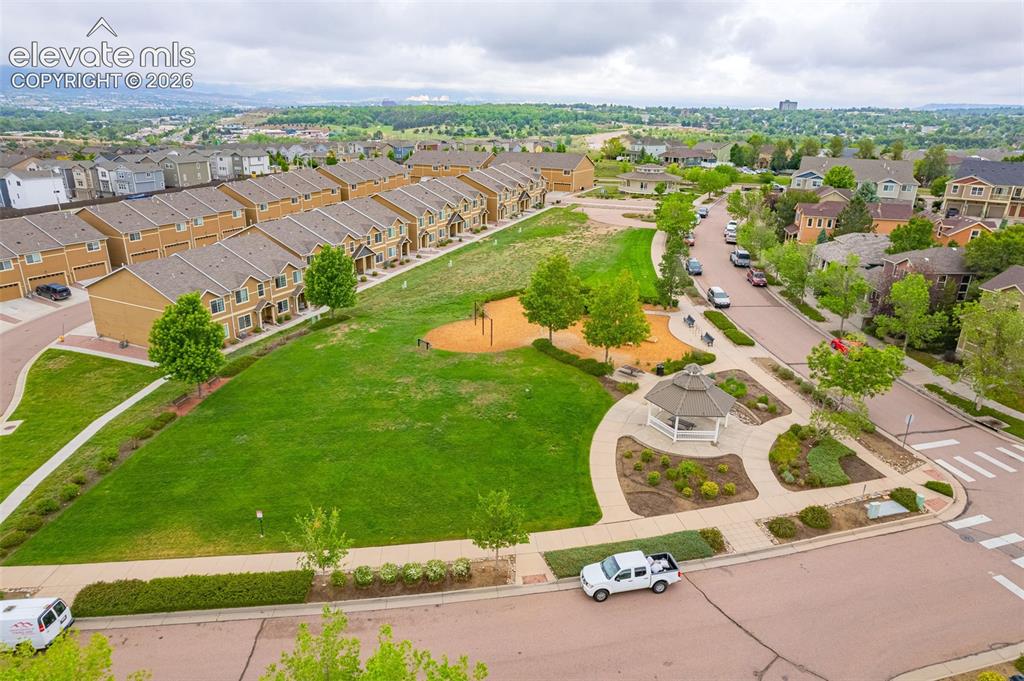 Image 29 of 38: Community green space featuring a gazebo, walking paths, and mature landsca