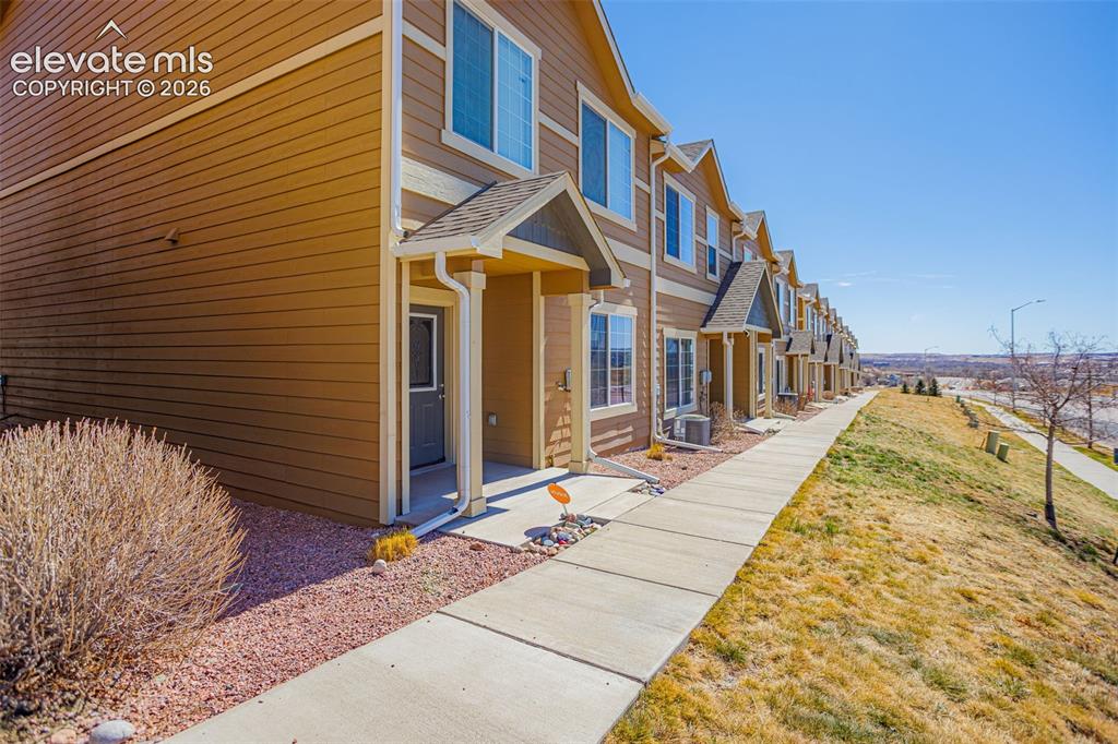 Image 3 of 38: Property entrance with a lawn