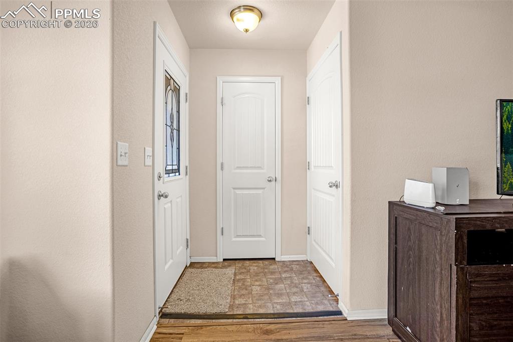 Image 4 of 30: Entryway featuring baseboards and light wood-type flooring