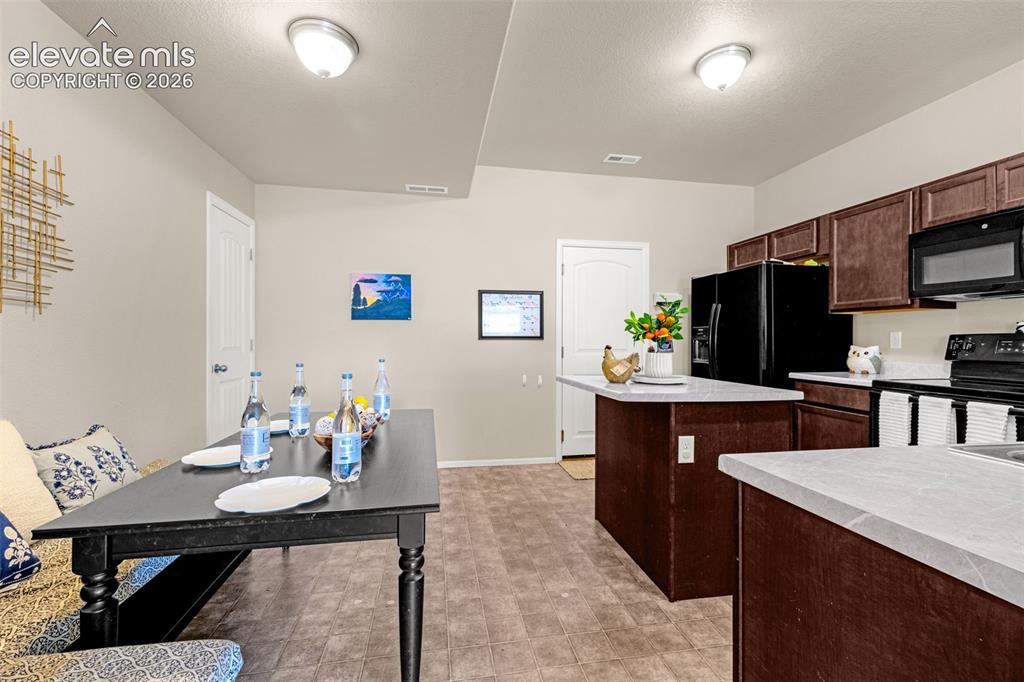 Image 7 of 38: Kitchen area featuring wood-finish flooring and cream-toned walls