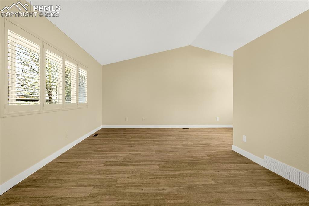Image 4 of 36: Unfurnished room with baseboards, visible vents, wood finished floors, and 