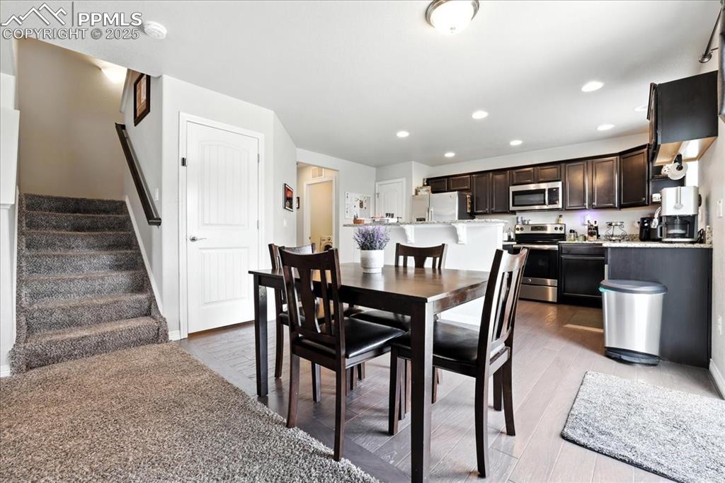 Image 10 of 31: Dining space featuring stairway, light wood-style floors, and recessed ligh