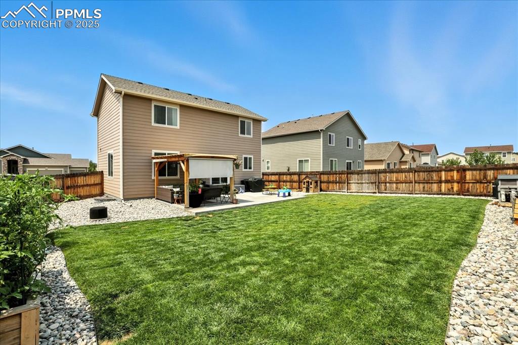 Image 27 of 31: Rear view of house with a fenced backyard, a patio, and a residential view
