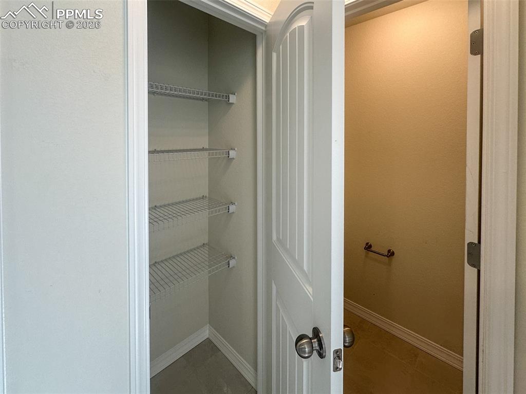 Image 18 of 34: Primary linen closet